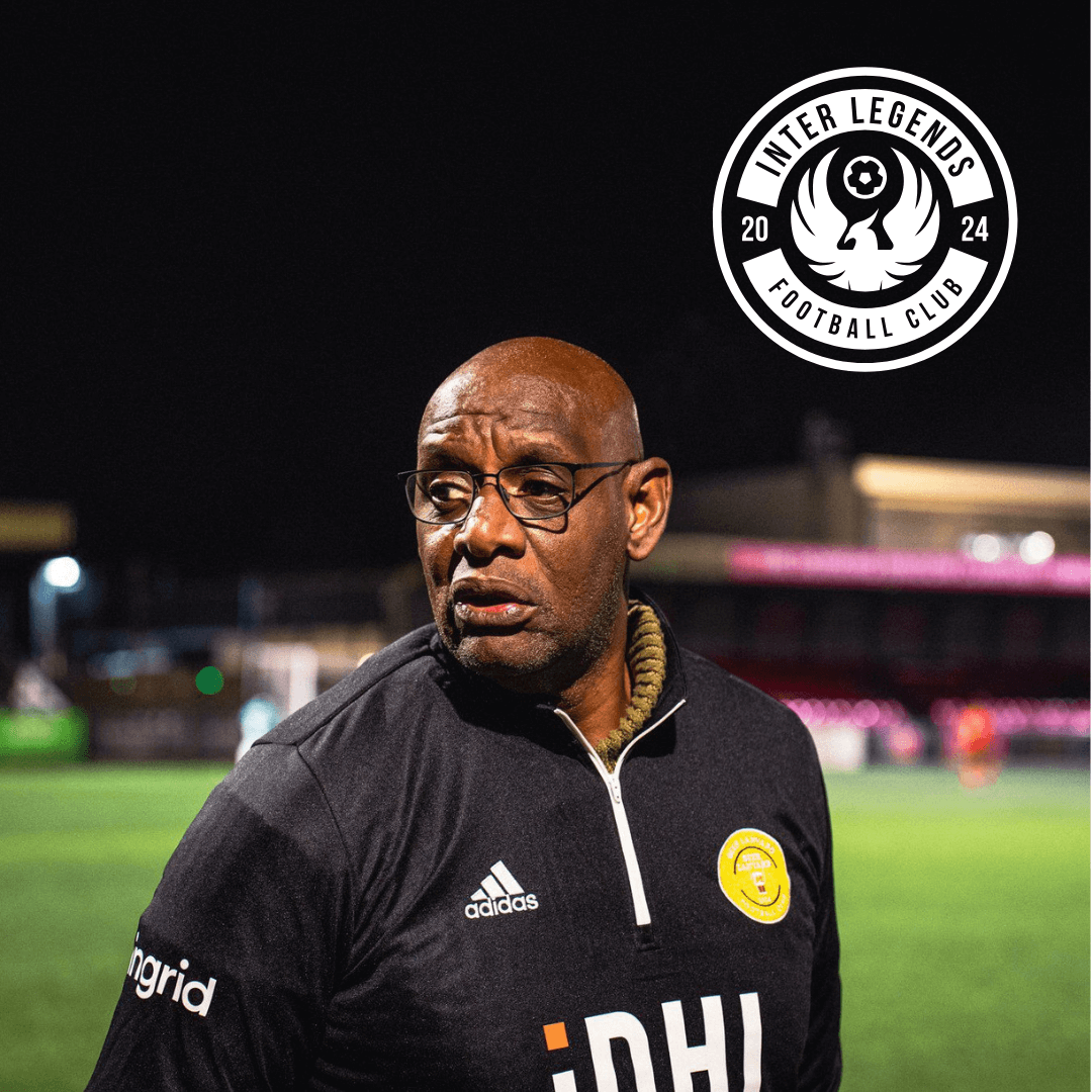 Shaun Wallace, manager of Inter Legends FC, reflecting on the pitch at night with the club logo.